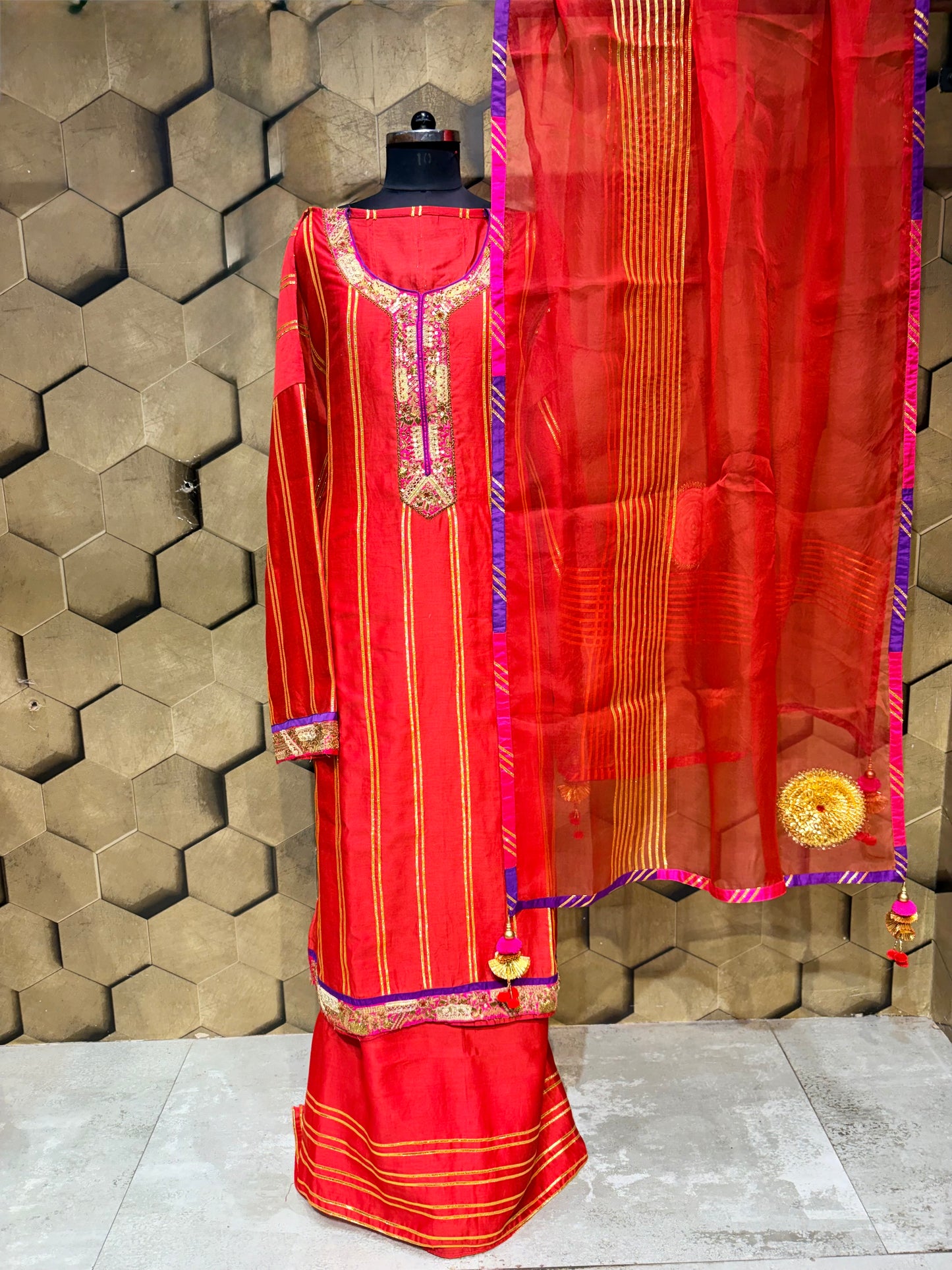 An exquisite festive masterpiece in a stunning coral red Chanderi fabric