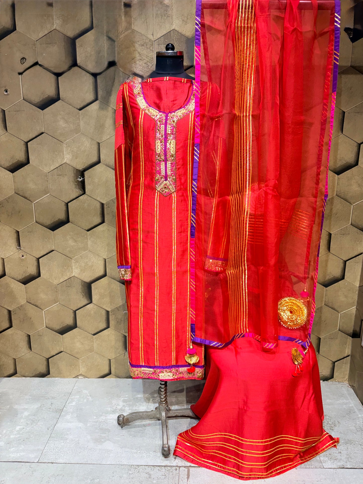 An exquisite festive masterpiece in a stunning coral red Chanderi fabric