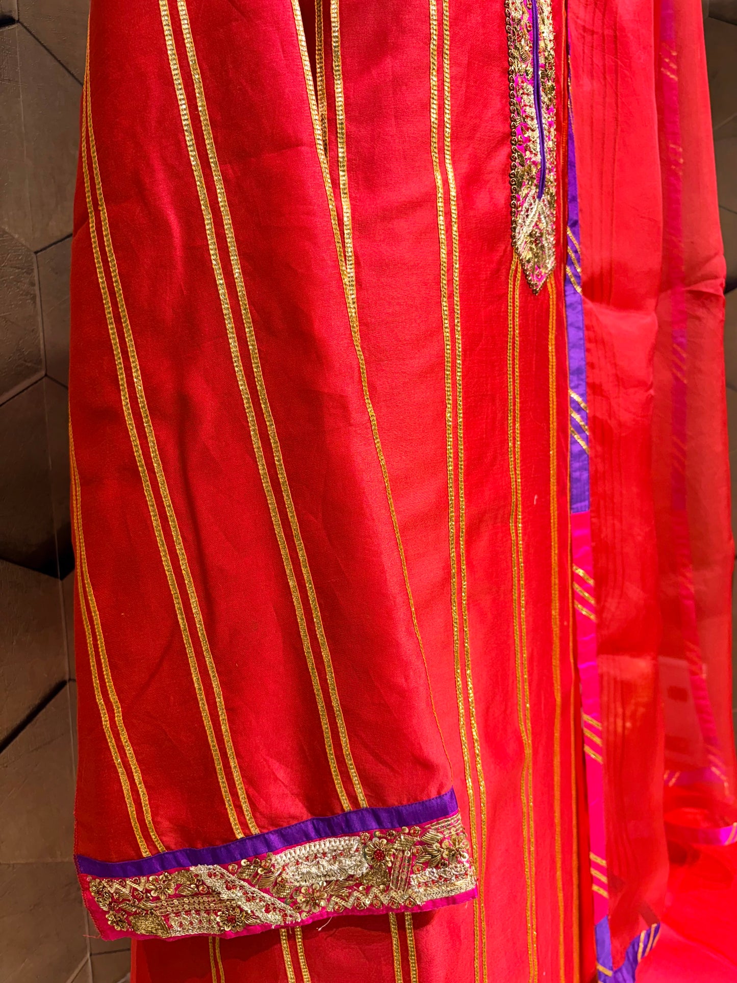 An exquisite festive masterpiece in a stunning coral red Chanderi fabric