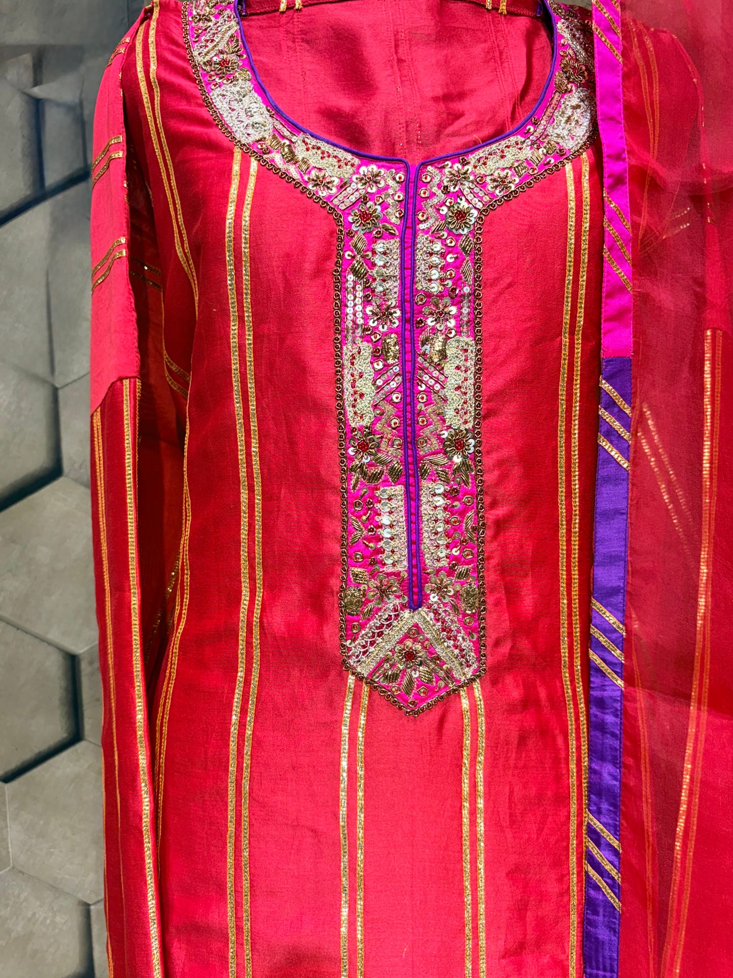 An exquisite festive masterpiece in a stunning coral red Chanderi fabric