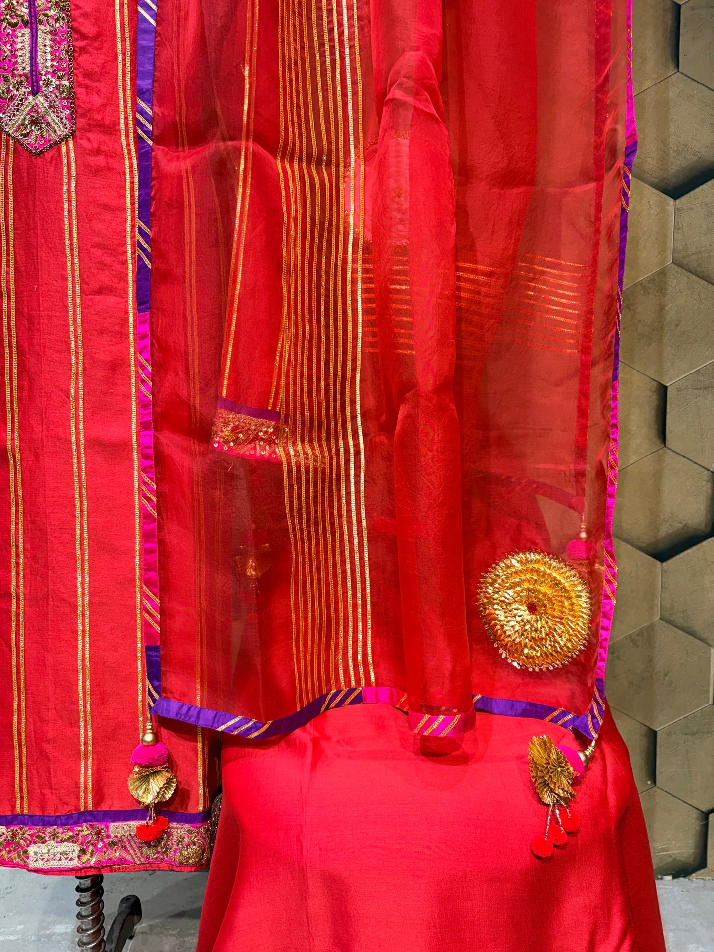 An exquisite festive masterpiece in a stunning coral red Chanderi fabric